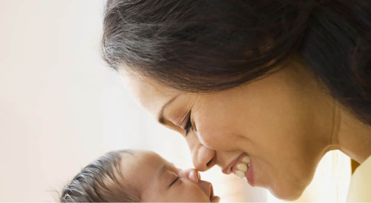 Mother lovingly gazing at her newborn baby